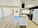 Eat-in kitchen with laminate flooring, granite countertops, stainless steel appliances, and recessed lighting at 658 Caribbean Dr, Davenport, FL 33897