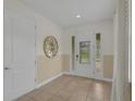 Inviting foyer with neutral tones, tile flooring, and a decorative mirror, creating a bright entrance at 7541 Marker Ave, Kissimmee, FL 34747