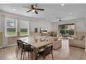 Spacious living room with tile flooring, neutral paint, and ample natural light from large windows at 7541 Marker Ave, Kissimmee, FL 34747