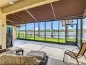 Spacious screened lanai offering picturesque views of the lake with comfortable seating at 777 Glendora Road, Poinciana, FL 34759