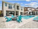 Inviting backyard featuring a shimmering pool, stylish lounge chairs, and a cozy fire pit for relaxation at 7802 Palmilla Ct, Reunion, FL 34747