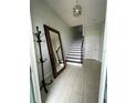 Bright entryway featuring modern tile flooring, a staircase, and a large mirror, creating an inviting ambiance at 8919 Lakeshore Pointe Dr, Winter Garden, FL 34787