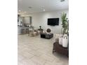 Open-concept living space flows seamlessly into the kitchen, perfect for modern living and entertaining at 8919 Lakeshore Pointe Dr, Winter Garden, FL 34787