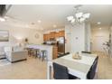 Open-concept living space featuring a dining area, modern furnishings, and natural light at 8942 Cuban Palm Rd, Kissimmee, FL 34747