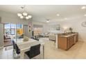 Open-concept living space featuring a dining area, modern furnishings, and natural light at 8942 Cuban Palm Rd, Kissimmee, FL 34747