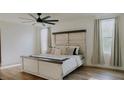 Bright main bedroom with a rustic headboard, neutral tones, and a large ceiling fan at 9345 Atlanta Dr, St Cloud, FL 34773