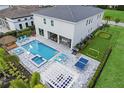 Home's backyard boasts a pool, spa, outdoor kitchen, putting green and entertaining space at 1005 Coyote Creek Way, Reunion, FL 34747