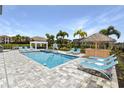 Outdoor pool area features a Tiki bar, a basketball hoop and plenty of lounge seating at 1005 Coyote Creek Way, Reunion, FL 34747