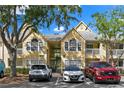 Inviting two-story condo building with well-maintained landscaping and convenient parking at 1025 S Hiawassee Rd # 2225, Orlando, FL 32835