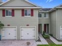 Close-up of the exterior of the townhome showcasing the garage and entry door at 10746 Regent Square Dr # 1502, Orlando, FL 32825