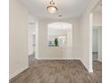 Open-concept living space with wood-look tile flooring and an archway to the dining area at 1101 Downswing Pl, Davenport, FL 33896