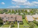 Aerial view showcasing the townhome's landscaping and proximity to nearby apartments and parking at 13636 Beauregard Pl, Orlando, FL 32837