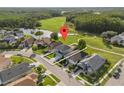 Aerial view of a charming home in a suburban neighborhood near a park and pond at 14412 Saint Georges Hill Dr, Orlando, FL 32828
