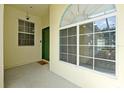 Inviting entryway featuring a large window and green door creating a warm and welcoming entrance at 168 Club Villas Ln, Kissimmee, FL 34744