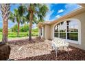 Lovely home exterior with arched windows, mature landscaping, and an inviting sitting bench at 2063 E Prairie Cir, Deltona, FL 32725