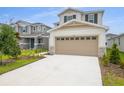 Beautiful two-story home with a wide driveway and manicured front yard at 208 Flag Lilly Ln, Umatilla, FL 32784