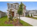 Charming two-story home featuring a neutral color scheme, stone accents, and fresh landscaping at 216 Flag Lilly Ln, Umatilla, FL 32784