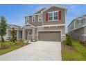 Inviting two-story home with a neutral color scheme, stone accents, and well-manicured landscaping at 216 Flag Lilly Ln, Umatilla, FL 32784