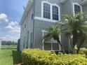 Two-story house with view of the lake behind the palm trees and manicured green shrubs at 2255 Stone Lake Ct, Orlando, FL 32824