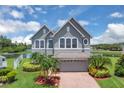 Charming two-story home with a well-maintained lawn and beautiful landscaping in a waterfront community at 2255 Stone Lake Ct, Orlando, FL 32824