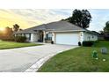 Inviting exterior view of single-story home showcasing the driveway, attached garage, and landscaped yard at 3 Sunrise Dr, Ocala, FL 34472