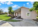Inviting home exterior with a covered entryway, manicured landscaping, and a welcoming walkway at 3 Trophy Ln, Kissimmee, FL 34759