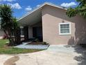 Cozy single-story home featuring a charming front yard with mature trees and a covered entrance at 3 Trophy Ln, Kissimmee, FL 34759