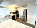Well-lit kitchen featuring stainless steel appliances, white cabinets, and updated countertops at 3 Trophy Ln, Kissimmee, FL 34759