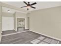 Bright living room featuring modern gray wood flooring, neutral walls, and a ceiling fan at 3 Trophy Ln, Kissimmee, FL 34759
