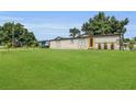 Inviting single-story home features a well-manicured lawn, and a bright yellow front door at 3173 Wake Up Ct, Kissimmee, FL 34744