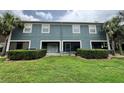 Back exterior view with a lawn, shrubbery, and patios with screen doors at 3664 Wilshire Way Rd # 261, Orlando, FL 32829