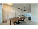 Neutral dining area featuring white walls, dark table, and a view of the couch and sliding glass door at 3901 Ballinore Pl, Gotha, FL 34734