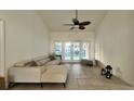 Cozy living room area with a comfortable couch, bench, and access to a screened in pool area at 3901 Ballinore Pl, Gotha, FL 34734