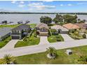 Aerial view of homes with waterfront views and community docks on a sunny day, with green lawns at 3991 Island Lakes Dr, Winter Haven, FL 33881