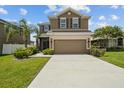 Charming two-story home with well-maintained landscaping, and double car garage with long driveway at 3991 Island Lakes Dr, Winter Haven, FL 33881