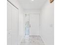 Bright entryway with marble-look floors and a coat closet at 406 Long Dr, Kissimmee, FL 34759