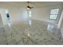 Spacious living room with tiled floors, fan and lots of natural light at 406 Long Dr, Kissimmee, FL 34759