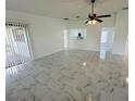 Open-concept living room featuring modern tile flooring and seamless transition to a breakfast bar and kitchen at 406 Long Dr, Kissimmee, FL 34759