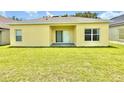 The back of the home features a patio area and a spacious backyard with a lush green lawn at 4307 Creeks Run Blvd, Kissimmee, FL 34746