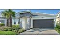 Lovely home featuring an attached garage, paver driveway, well-maintained lawn and pretty landscaping at 4504 Monado Dr, Kissimmee, FL 34746