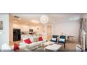 Open-concept living area with dining room and island kitchen featuring modern decor and white tile flooring at 4504 Monado Dr, Kissimmee, FL 34746