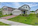 Charming two-story home with brick driveway, attached two car garage, and small front yard at 5288 Stephs Field St, St Cloud, FL 34771