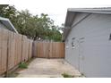 Spacious backyard area with a wooden fence offering privacy and potential at 5810 Paradise Ln, Orlando, FL 32808