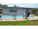 Backyard pool with patio space offers a great space for relaxing and entertaining outdoors at 5810 Paradise Ln, Orlando, FL 32808
