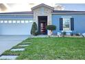 Delightful single-story home with walkway, two-car garage, and manicured front lawn at 585 Lucerne Blvd, Winter Haven, FL 33881