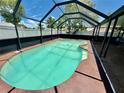 A private in-ground pool is enclosed by a screen cage and surrounded by concrete at 651 Elderwood Ct, Kissimmee, FL 34743
