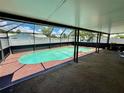 A private in-ground pool is enclosed by a screen cage and surrounded by concrete at 651 Elderwood Ct, Kissimmee, FL 34743