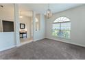 Bright living room with a large arched window and neutral carpeting at 6644 Sw 179Th Court Rd, Dunnellon, FL 34432