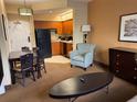 Cozy suite featuring a dining table, comfortable armchair, and a fully equipped kitchen at 7601 Canada Ave, Orlando, FL 32819