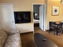 Well-appointed suite with a sofa, TV, and dining area, perfect for relaxation and entertainment at 7601 Canada Ave, Orlando, FL 32819